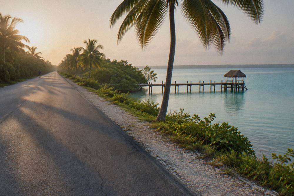 Open highway running south through green jungle toward Bacalar under a wide sky