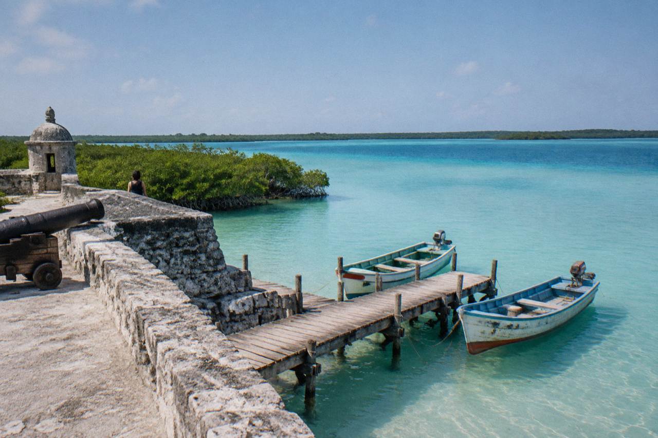 Turquoise water of Bacalar Lagoon under morning light with a wooden jetty