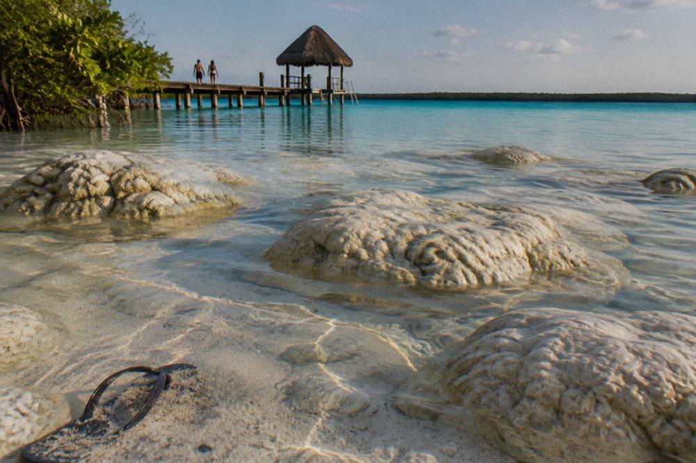 Clear shallow water over pale sand in Bacalar Lagoon near the shore